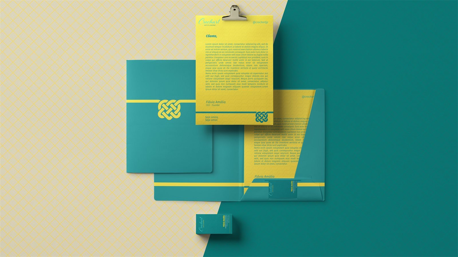 Papelaria da Crochart sobre um fundo dividido entre a padronagem de nós amarela e o verde-petróleo: pasta, cartões de visita e papel timbrado com a frase Seja única, seja amor.